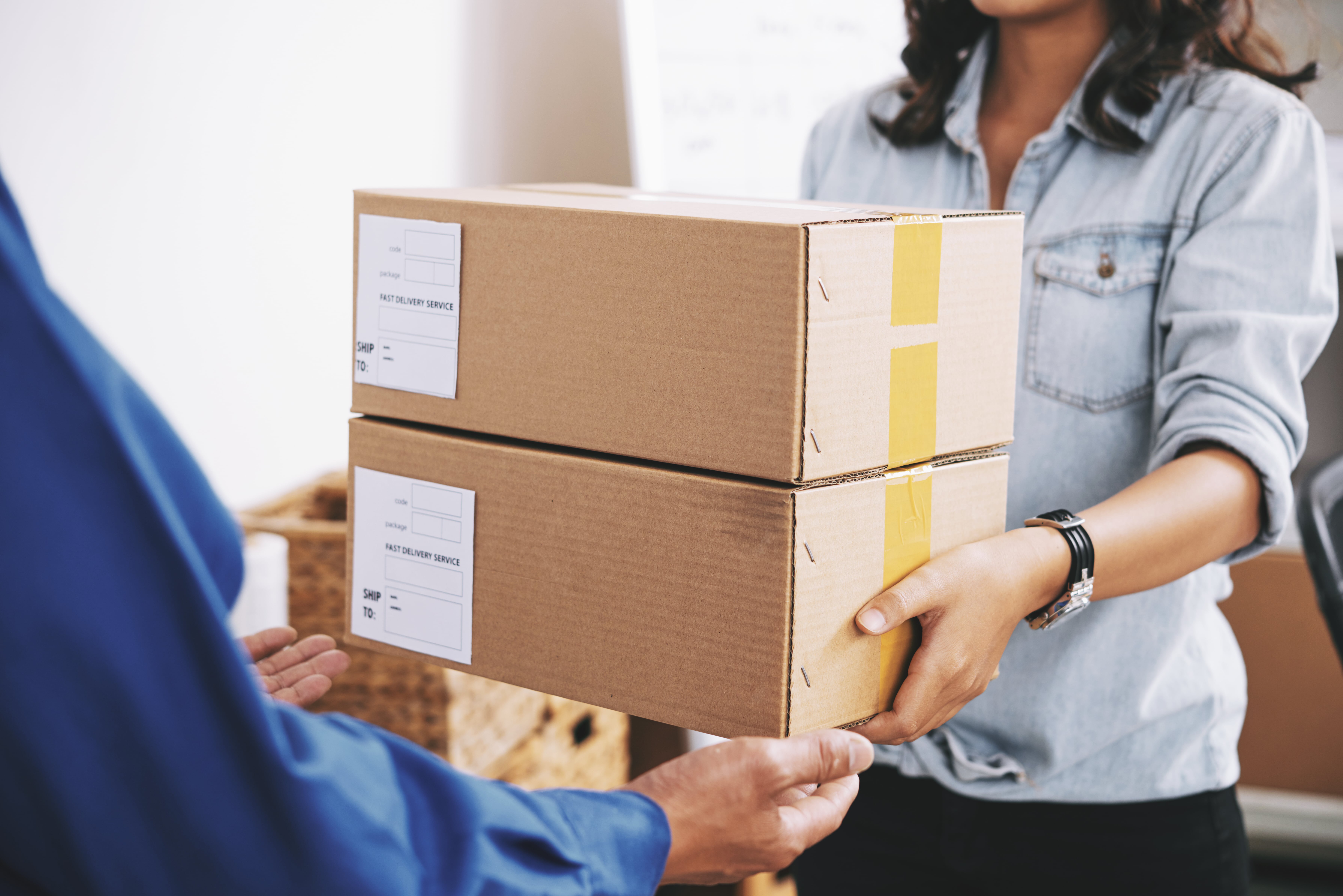 Virtual mailbox employee giving packages to customer